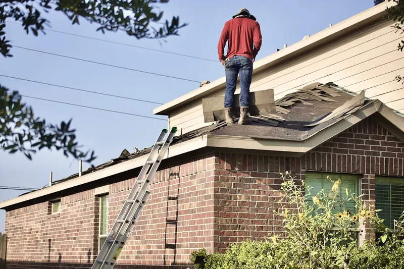 Professional roofer working on a residential roof in Bridgeboro